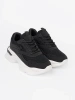Black sporty sneakers on thick white sole