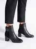 Chic Black Heeled Boots with Decorative Strap
