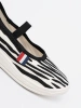 Black and white lightweight slip-on sneakers with zebra motif