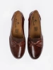 Brown slip-on loafers with a bow