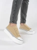 Beige women's sneakers with a thick sole