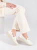 White wedge loafers with decorative chain