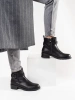 Black ankle boots with low heel decorated with straps