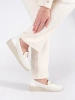 White wedge loafers with decorative chain