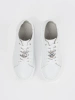 White leather sneakers with a pin by Sergio Leone