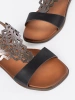 Black sandals with openwork embellishments