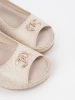 Beige wedge sandals with a buckle