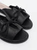 Black flat slides with a bow