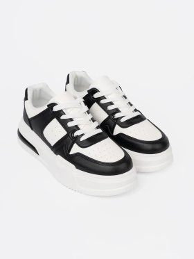 Stylish black and white sneakers with thick soles