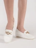 White platform loafers with gold embellishment