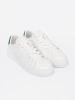Classic white sneakers with a green accent