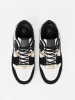 Black and white sneakers with gold details