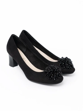 Black pumps with decorative beaded brooch