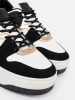Czarno białe sneakersy ze złotymi detalami
