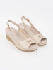 Beige wedge sandals with a buckle