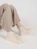 Light beige women's high-top sneakers on a platform