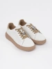 White and beige leather sneakers with a pin Sergio Leone