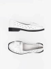 White perforated shoes with a bow