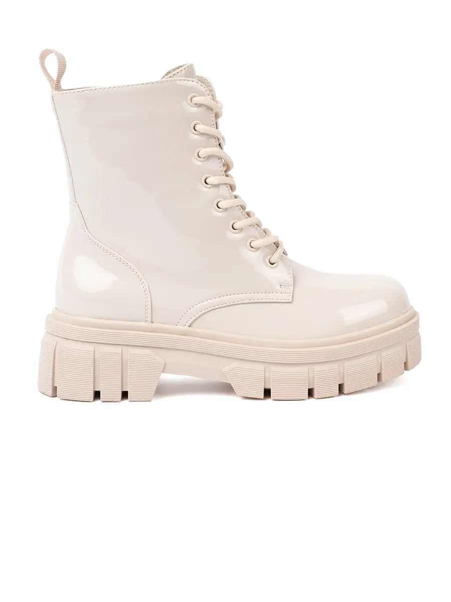 Stylish patent leather ankle boots in light beige shade