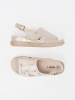 Light beige flat sandals with a buckle