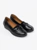Black slip-on loafers with a bow