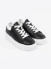 Women's black sneakers with white inserts