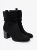 Black suede ankle boots on a column heel with ruched upper