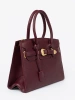 Burgundy handbag with decorative buckle in gold color