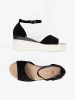 Black women's sandals on a white wedge