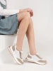 White-beige leather perforated sneakers on thick soles