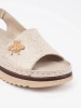 Beige platform sandals with a brooch