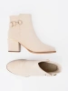 Light beige ankle boots with decorative buckle