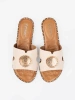 Light beige mules with a gold ornament