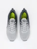 Gray sports shoes with a green element