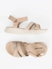 Light beige sandals on a white platform