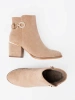 Elegant beige ankle boots with decorative buckle