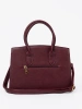 Burgundy handbag with decorative buckle in gold color