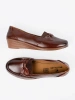 Brown slip-on loafers with a bow