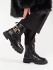 Black combat boots with a gold chain