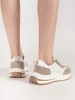 White-beige leather perforated sneakers on thick soles
