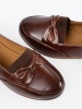 Brown slip-on loafers with a bow