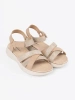Light beige sandals on a white platform