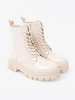 Stylish patent leather ankle boots in light beige shade