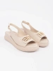 Beige sandals with embellishment