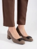 Beige block heeled pumps with a bow
