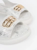 White flat sandals with embellishment