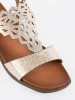 Gold sandals with openwork embellishments