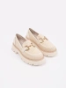 Beige platform loafers with a gold chain