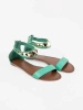 Green ankle-strap sandals with gold ornament