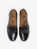 Black slip-on loafers with a bow